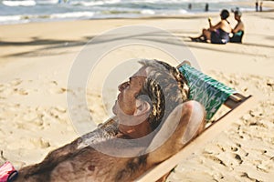 Senior man chilling on the beach photo