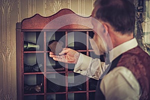 Senior man choosing custom made bow ties and neckties.