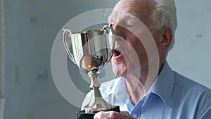 Senior man cleaning his trophy