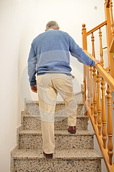 Senior man climbing the upstairs