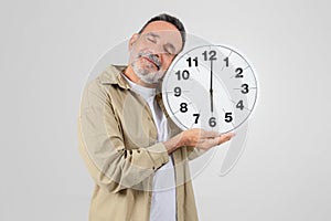Senior man with clock symbolizing time concept