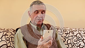 Senior man communicates through a smartphone. Man with mobile phone