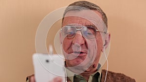 Senior man communicates through a smartphone. Man with mobile phone