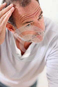 Senior man concerned about hair loss