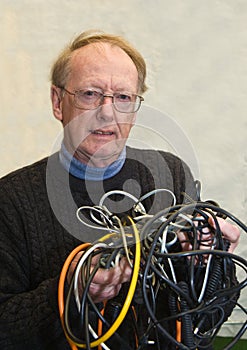 Senior man confused by tangled wires