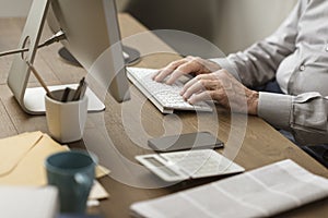 Senior man connecting with his computer at home