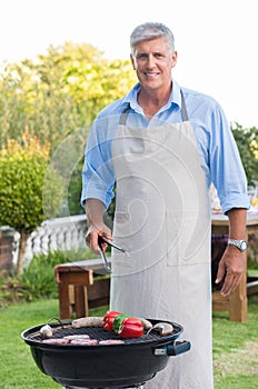 Senior man cooking barbeque