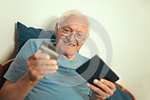 Senior man with credit card for on line banking