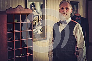 Senior man and custom made bow ties and neckties. photo