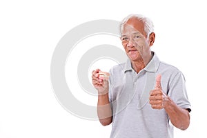 Senior man with denture, giving thumb up