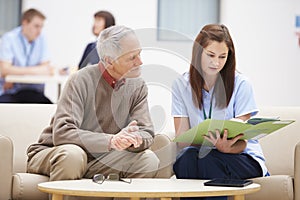 Senior Man Discussing Results With Nurse