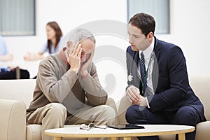 Senior Man Discussing Test Results With Doctor