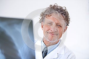 Senior man, doctor and portrait with xray for healthcare, injury analysis or anatomy with radiology and smile. Mature