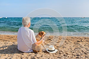 Senior man with dog at the beach