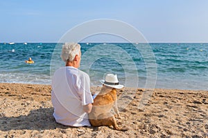 Senior man with dog at the beach