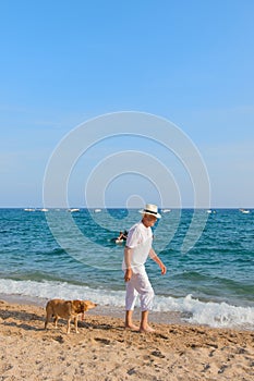 Senior man with dog at the beach