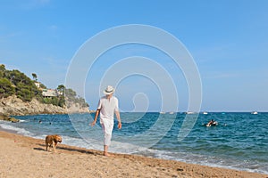 Senior man with dog at the beach