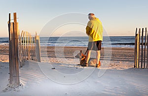 Senior Man with Dog Enjoying Morning on North Carolina Beach
