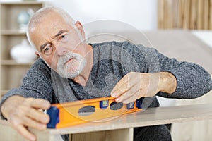 senior man doing diy works