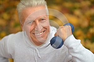 Senior man with dumbbell