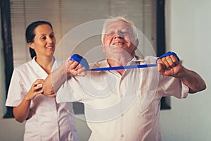 Senior man doing exercises using a strap