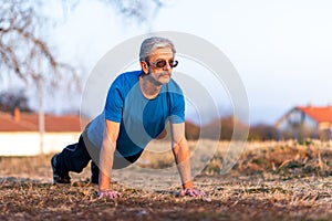 Senior Man doing pushups on a workout
