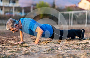 Senior Man doing pushups on a workout