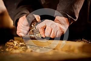 Senior man doing woodworking photo