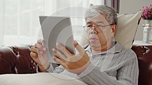 Senior man doze asleep while listening music on couch