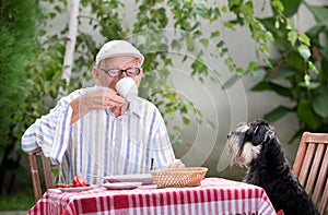 Senior man drinking coffee in garden