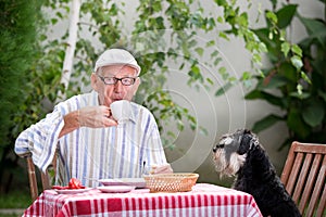 Senior man drinking coffee in garden