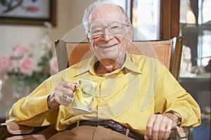 Senior man drinking hot beverage