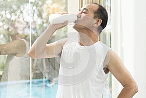 Senior man drinking milk.