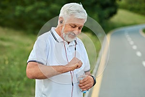 Senior man drinking water while morning scamper.