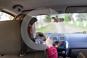 Senior man driving car