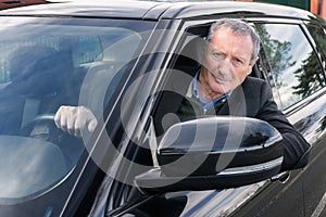 Senior man driving car