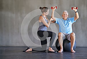 Senior man, dumbbells or physical therapy for health, fitness or medical assessment on wall background. Physiotherapy