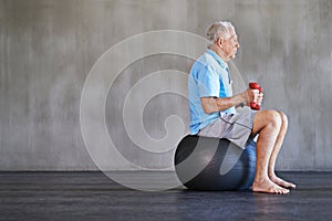 Senior man, dumbbells and workout with ball for fitness, wellness and physiotherapy at gym on mockup space. Elderly
