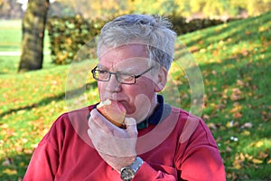 Senior man eating apple