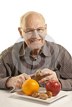 Senior man eating fresh fruit