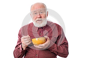 Senior man eating from oragne bowl , isolated on white