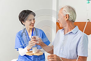 Senior man eats pills before lunch at retirement home