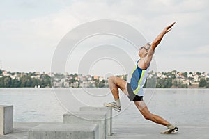 senior man is engaged in sports on the lake embankment