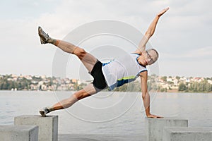 senior man is engaged in sports on the lake embankment