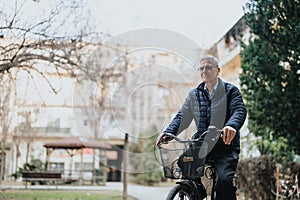 Senior man enjoying a leisurely bike ride in a peaceful urban park setting.