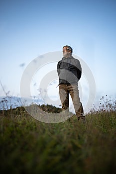 Senior man enjoying the outdoors walking throught lovely nature