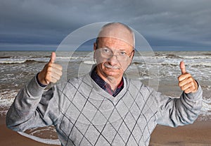 Senior man enjoying the outdoors with wavy sea