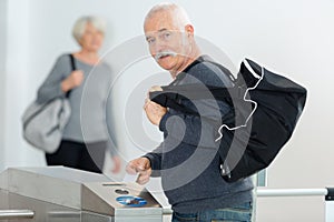 Senior man entering swimming in pool