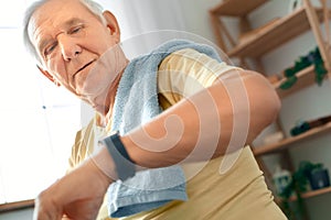 Senior man exercise at home health care checking time serious