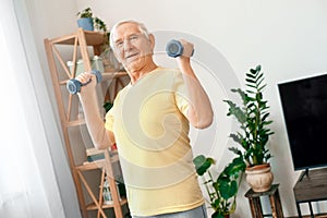 Senior man exercise at home health care with dumbbells strong